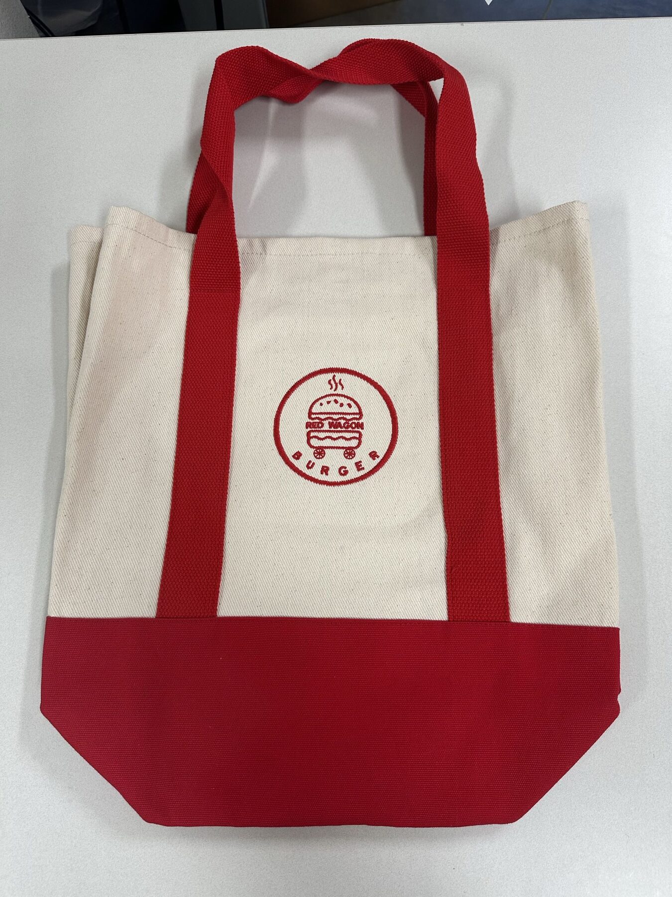 Canvas tote bag embroidered with the Red Wagon Burger logo